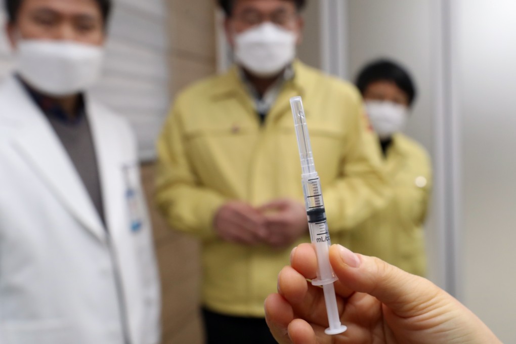 A medical worker holds up a shot containing AstraZeneca's Covid-19 vaccine during a roll-out at a South Korean hospital. Photo: DPA
