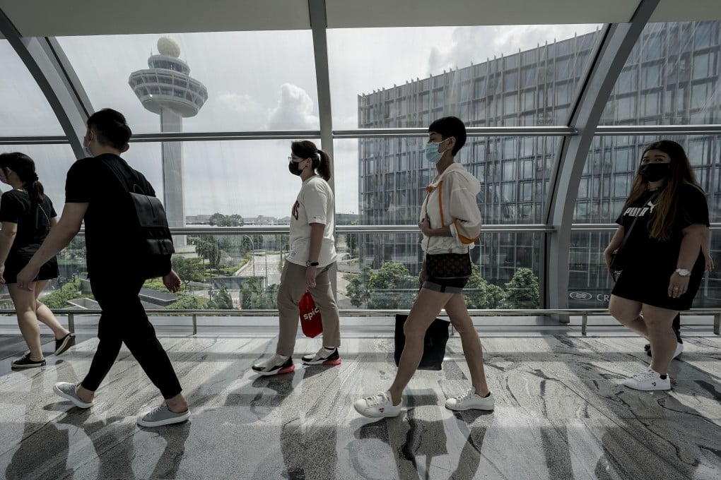 Travellers walk along a link bridge connecting the terminal building to the Jewel Changi airport mall in Singapore. Photo: EPA
