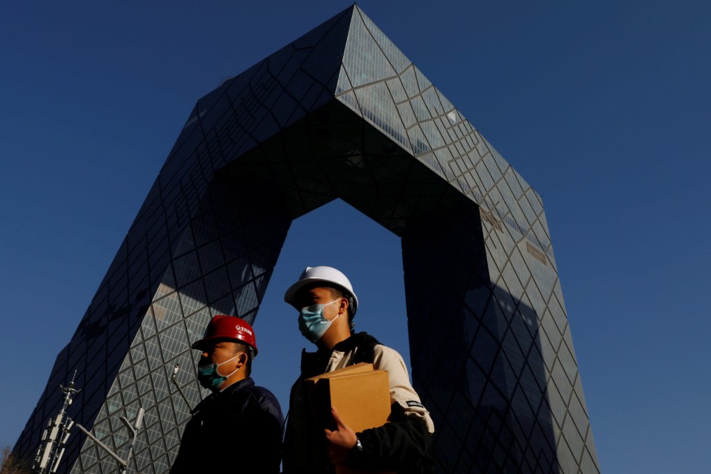 People walk past the CCTV headquarters, home of the Chinese state media outlet and its English-language sister channel CGTN, in Beijing in February. Photo: Reuters