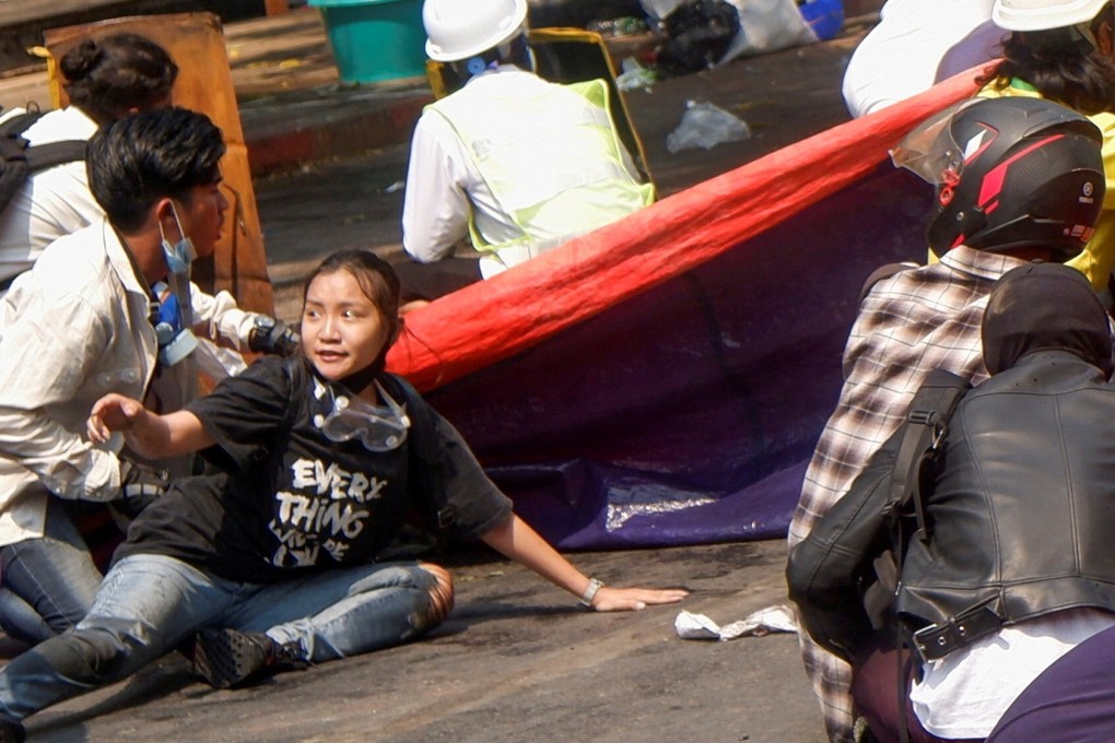 Protesters lie on the ground after police opened fire to disperse an anti-coup protest in Mandalay, Myanmar, on March 3, 2021. Among them, Angel, 19 (bottom-left), also known as Kyal Sin, took cover before she was shot in the head. Photo: Reuters