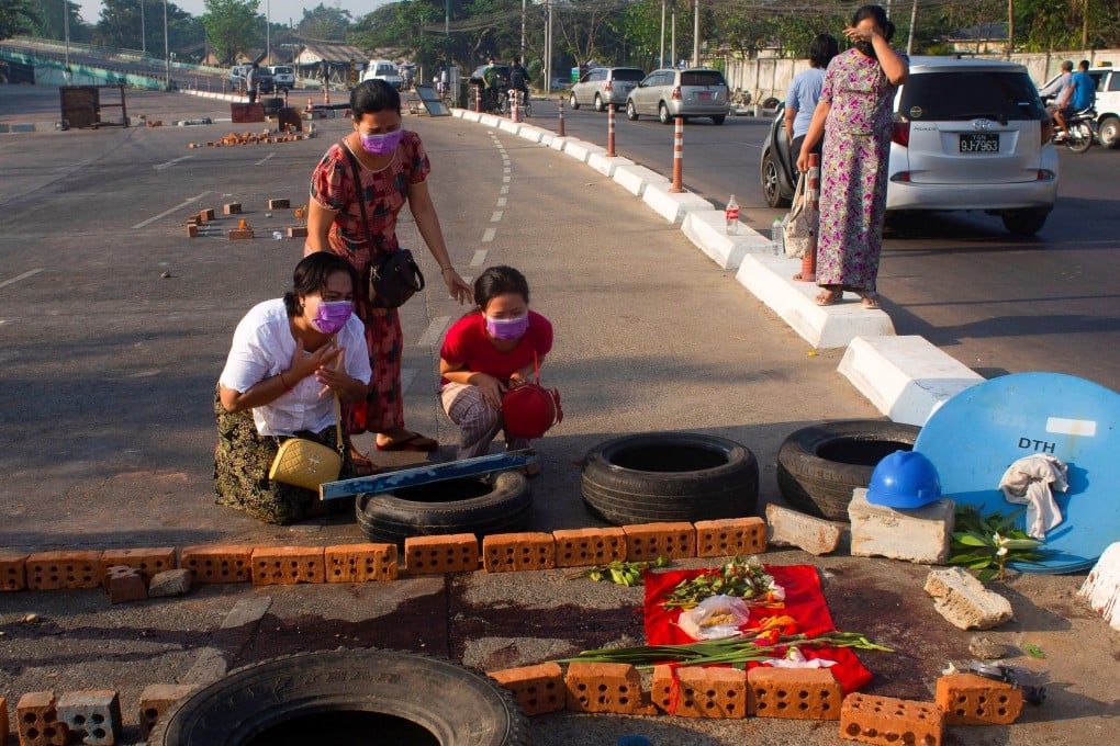 Family members cry near a spot in Yangon where a protester was killed during a demonstration against the military coup. Photo: Reuters
