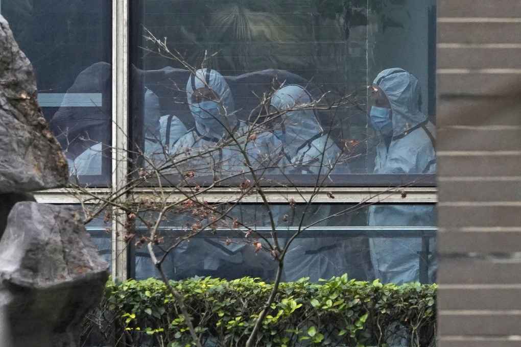 Members of a World Health Organization team are seen wearing protective gear during a field visit to the Hubei Animal Disease Control and Prevention Centre in Wuhan in February. Photo: AP
