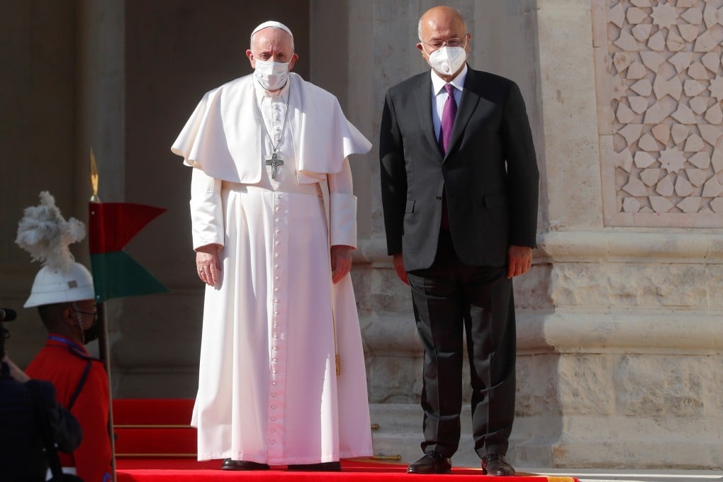 Pope Francis and Iraqi President Barham Salih attend a welcoming ceremony at the Presidential Palace in Baghdad on Friday March 5. Photo: Reuters