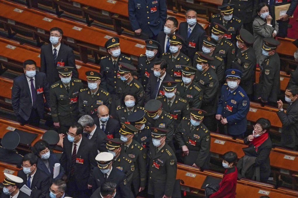 Military delegates leave the opening session of the National People’s Congress in Beijing on Friday. Photo: AP