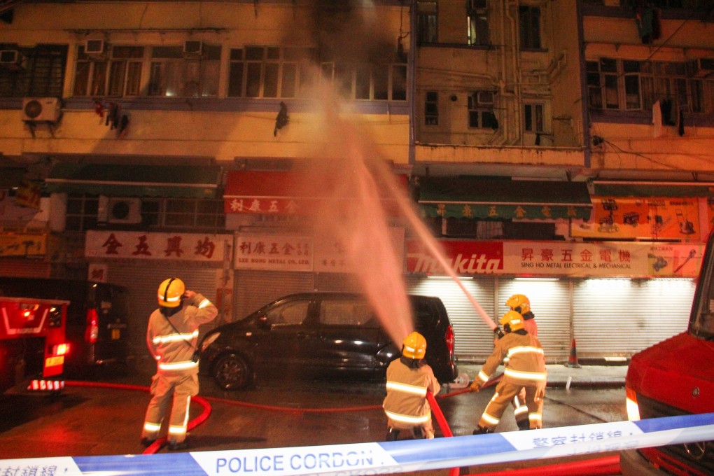 Firefighters battle a blaze at a Yau Ma Tei tenement early on Saturday morning. Photo: Handout