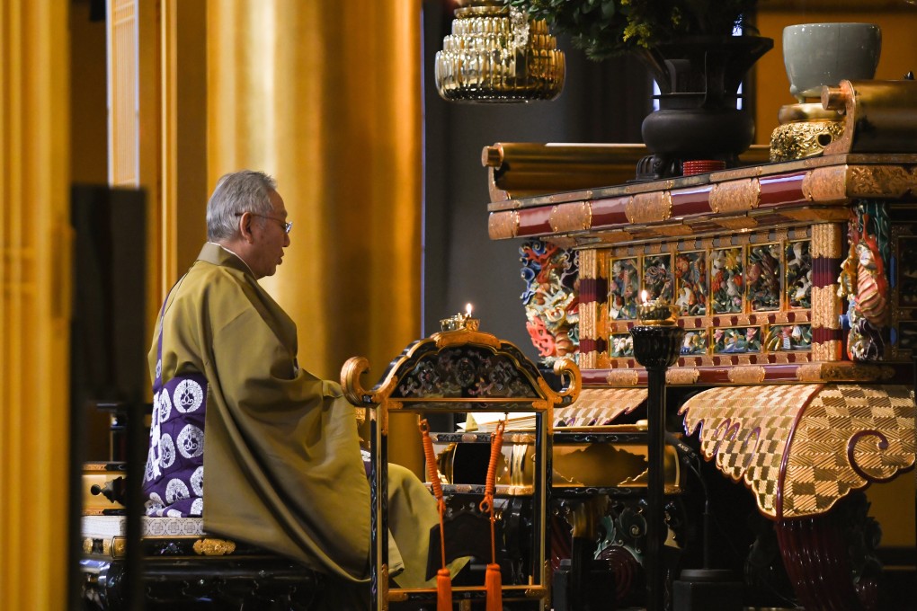 A priest performs morning prayers at Tsukiji Hongwanji temple in Tokyo. Photo: Bloomberg