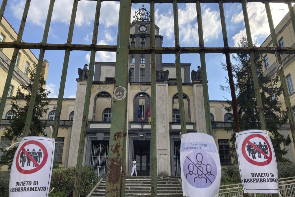 Signs in Italian saying “no gathering” hang from a closed gate of a primary school in Rome on Thursday. Photo: AP