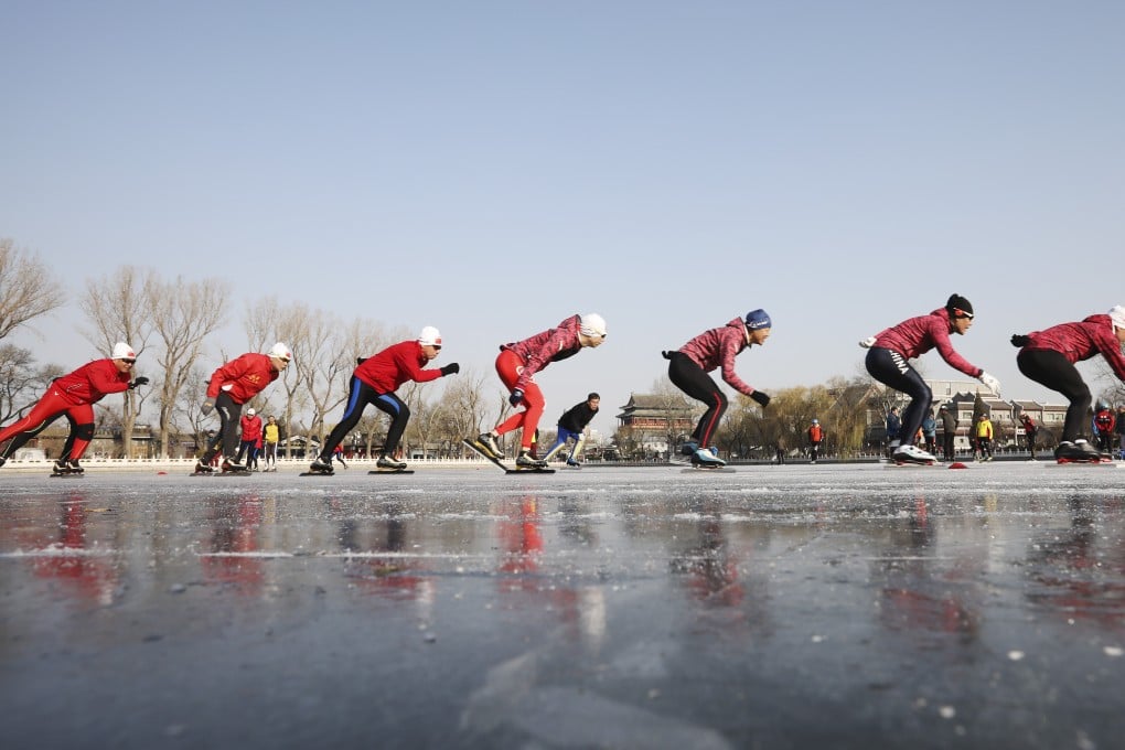Local winter sports enthusiasts skate on the frozen lake at Shichahai in downtown Beijing. Photo: SCMP / Simon Song