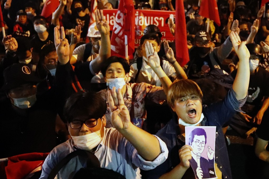 Anti-government protesters in Bangkok hold a drawing of one of their core leaders, Arnon Nampa, during a protest on Saturday. Photo: EPA-EFE