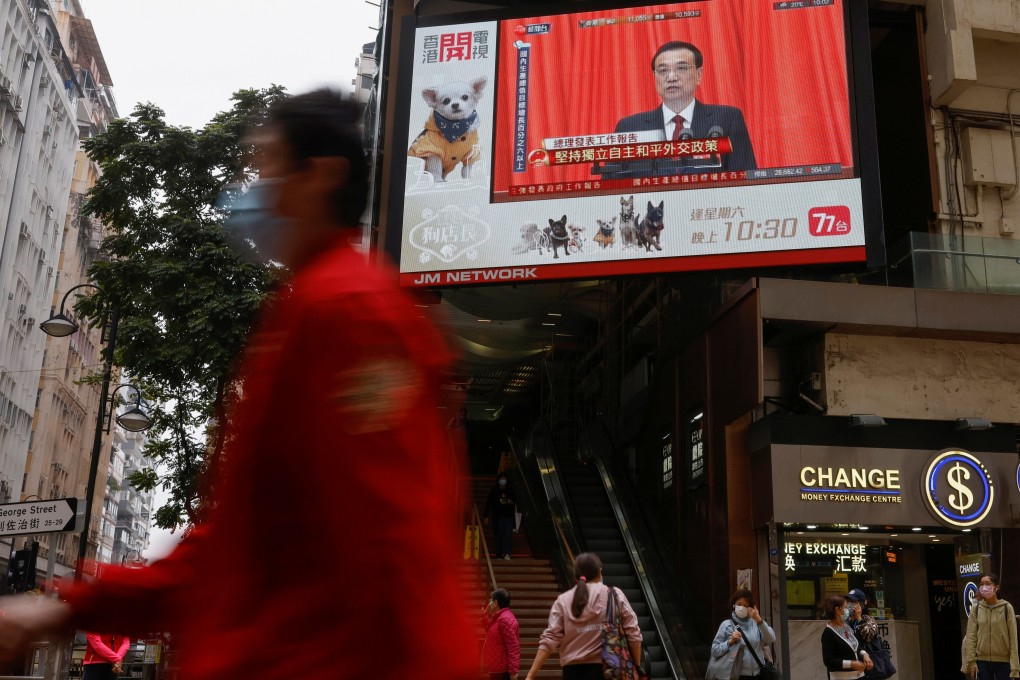 An outdoor screen in Hong Kong shows the opening session of the National People's Congress, where reforms were announced to the city’s electoral process. Photo: Reuters