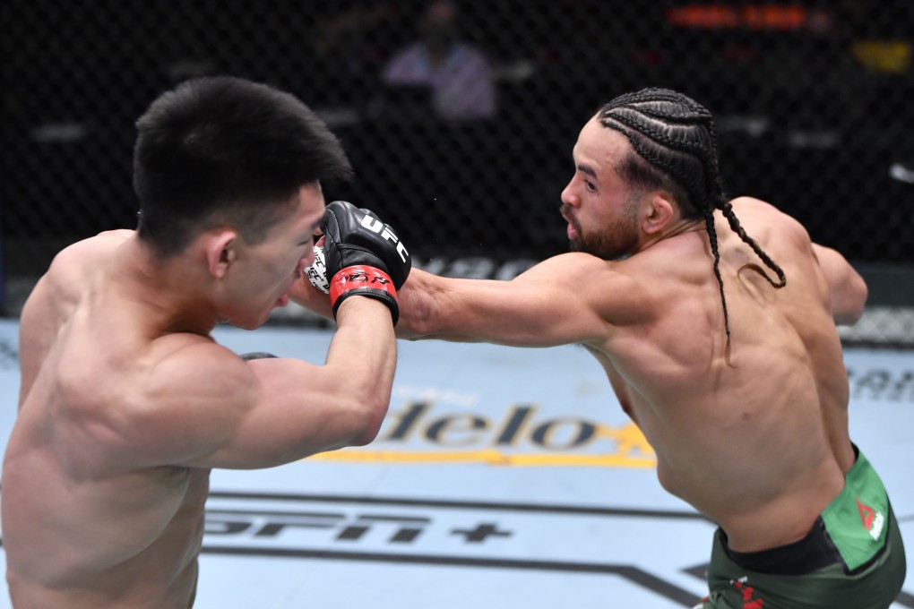 Kyler Phillips punches Song Yadong of China in their bantamweight fight during UFC 259. Photos: Jeff Bottari/Zuffa LLC
