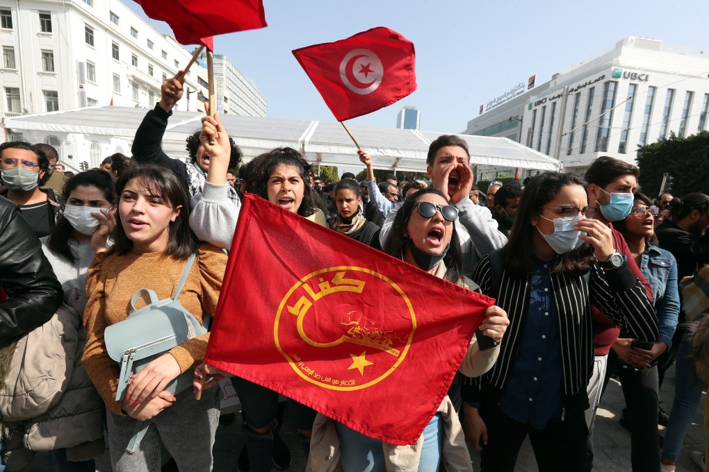 Tunisian protesters wave flags during a protest against the government in the capital Tunis on Saturday. Photo: EPA-EFE