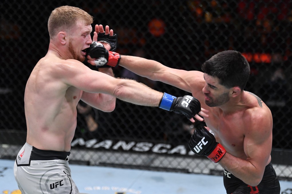 Dominick Cruz punches Casey Kenney in their bantamweight fight during UFC 259. Photos: Jeff Bottari/Zuffa LLC