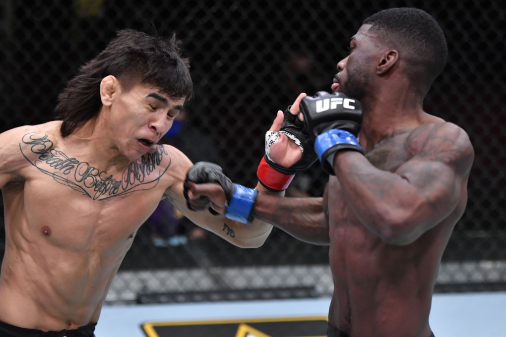 Trevin Jones punches Mario Bautista in their bantamweight fight during UFC 259. Photos: Jeff Bottari/Zuffa LLC