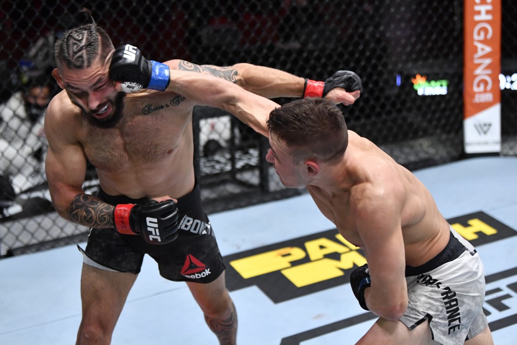Kai Kara-France punches Rogerio Bontorin in their flyweight fight during UFC 259. Photos: Jeff Bottari/Zuffa LLC