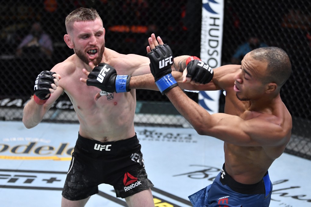 Tim Elliott punches Jordan Espinosa in their flyweight fight during UFC 259. Photos: Jeff Bottari/Zuffa LLC