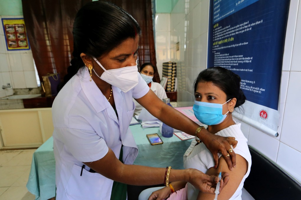 A woman receives a shot of Covid-19 vaccine in Bhopal, India. Photo: EPA