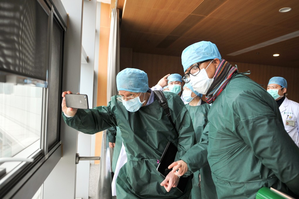 Members of the World Health Organization’s coronavirus expert investigation group at a hospital in Wuhan during their visit earlier in the year. Photo: TPG