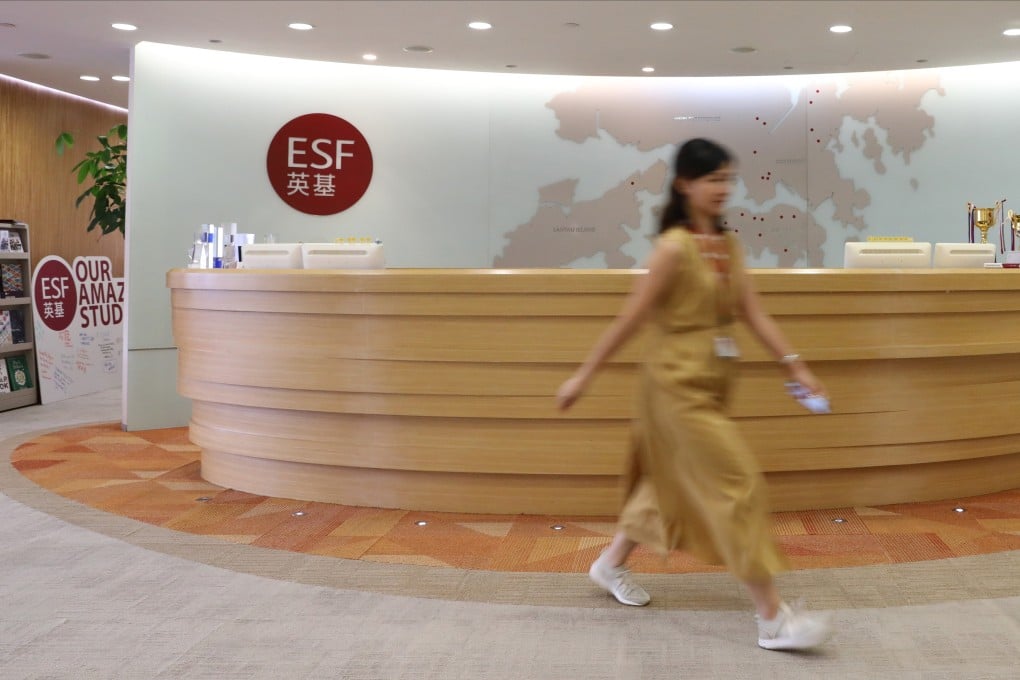 A staff member walks through the reception area of the English Schools Foundation office in Quarry Bay. Photo: May Tse