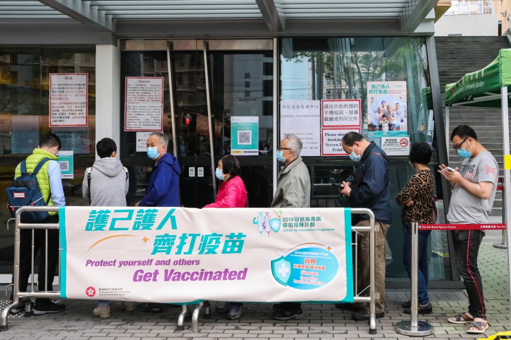 People queue up outside a vaccination centre in Tin Shui Wai on Monday. Photo: K. Y. Cheng