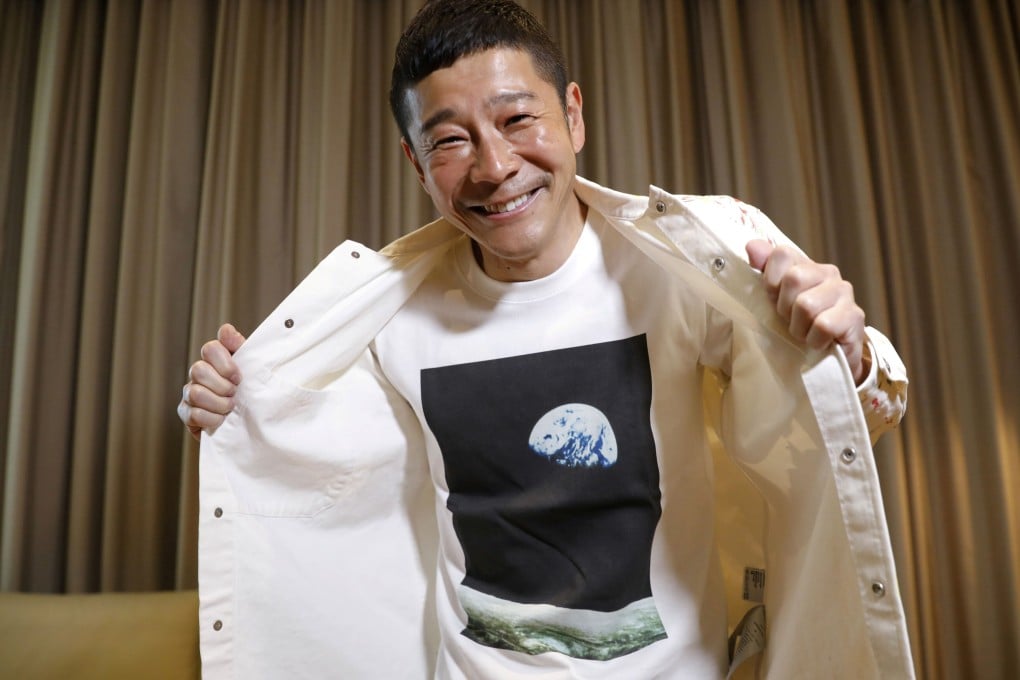 Japanese billionaire Yusaku Maezawa poses with his T-shirt bearing an image of Earth. Photo: Reuters