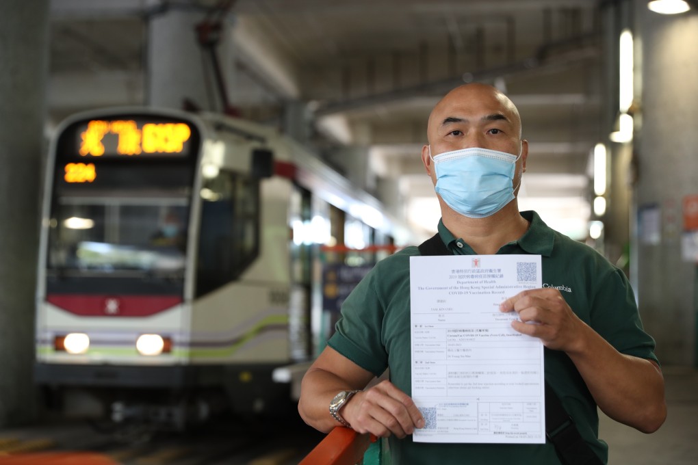 Tam Kin-chiu shows his Covid-19 vaccination record after getting the Sinovac jab at a clinic in Tuen Mun. Photo: Edmond So