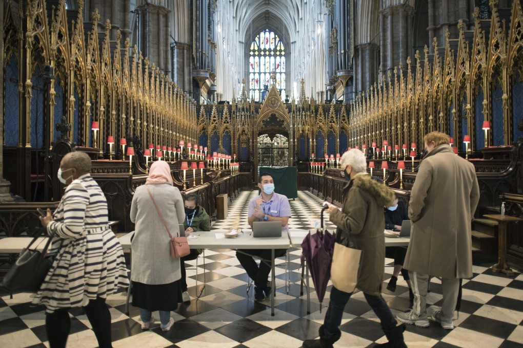 People arrive to get vaccinated against Covid-19 at Poets’ Corner in Westminster Abbey, London. Photo: PA via AP