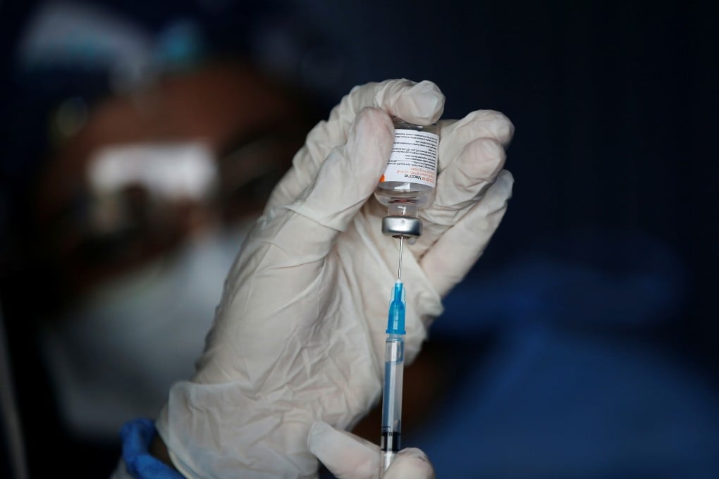 A health care worker prepares a dose of China's Sinovac Covid-19 vaccine. Photo: Reuters