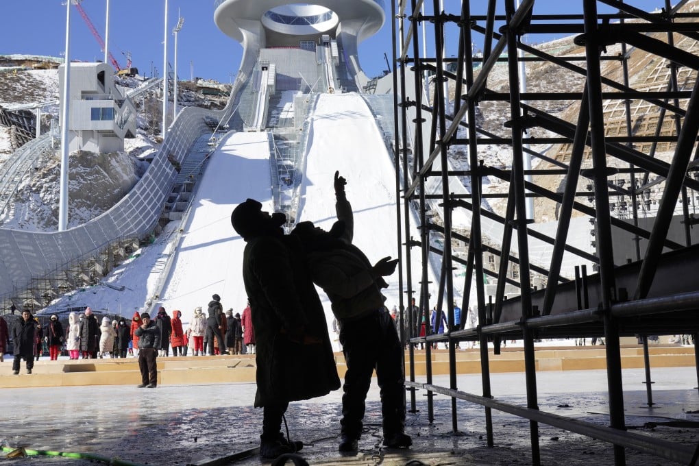 Workers discuss at the Zhangjiakou National Ski Jumping Centre under construction for the Beijing 2022 Winter Olympics in Zhangjiakou in Hebei province last December. Photo: AP
