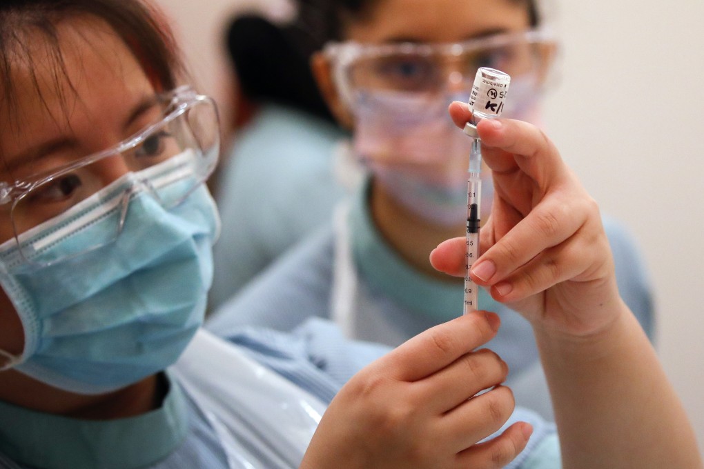 A Malaysian nurse prepares to administer a Covid-19 vaccine to a health worker. Photo: EPA