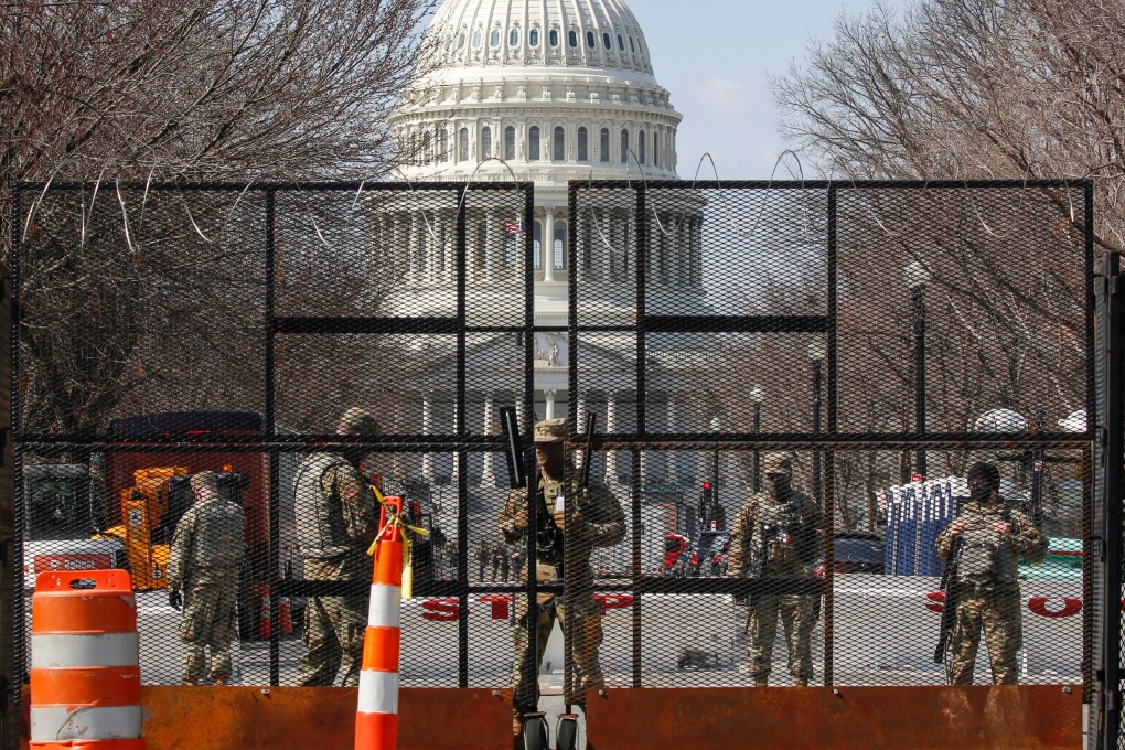 National Guard soldiers stand guard behind a security fence near the US Capitol on March 4, 2021. Photo: Reuters