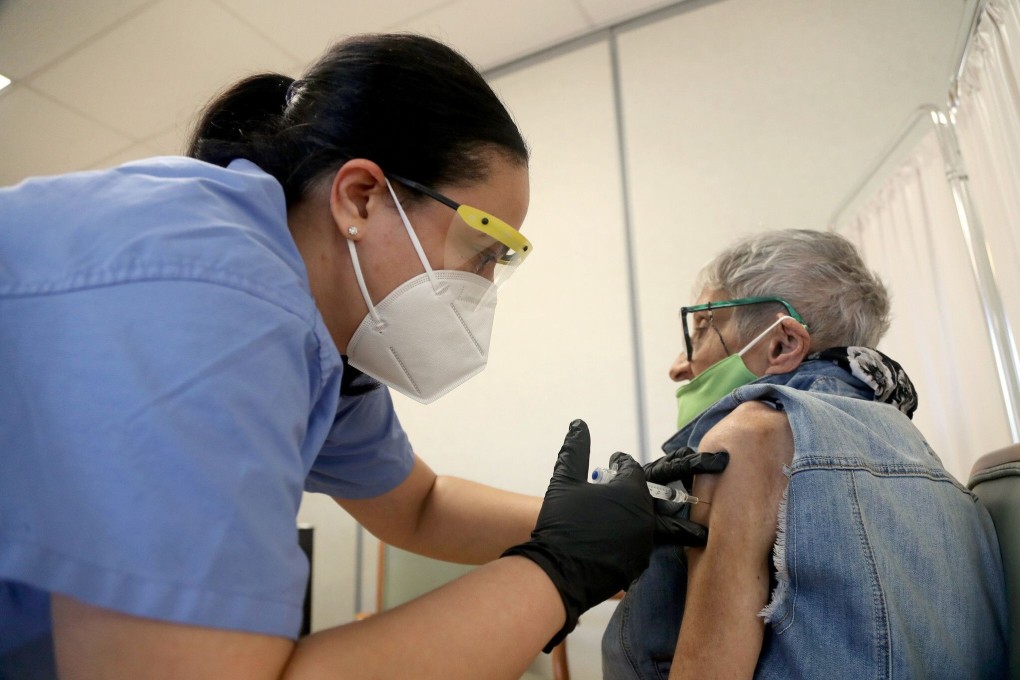 Nurse Latasha Bonnitto gives Marilyn Sarason, 86, her first dose of the Pfizer Covid-19 vaccine in Coral Springs, Florida, in January. Photo: TNS
