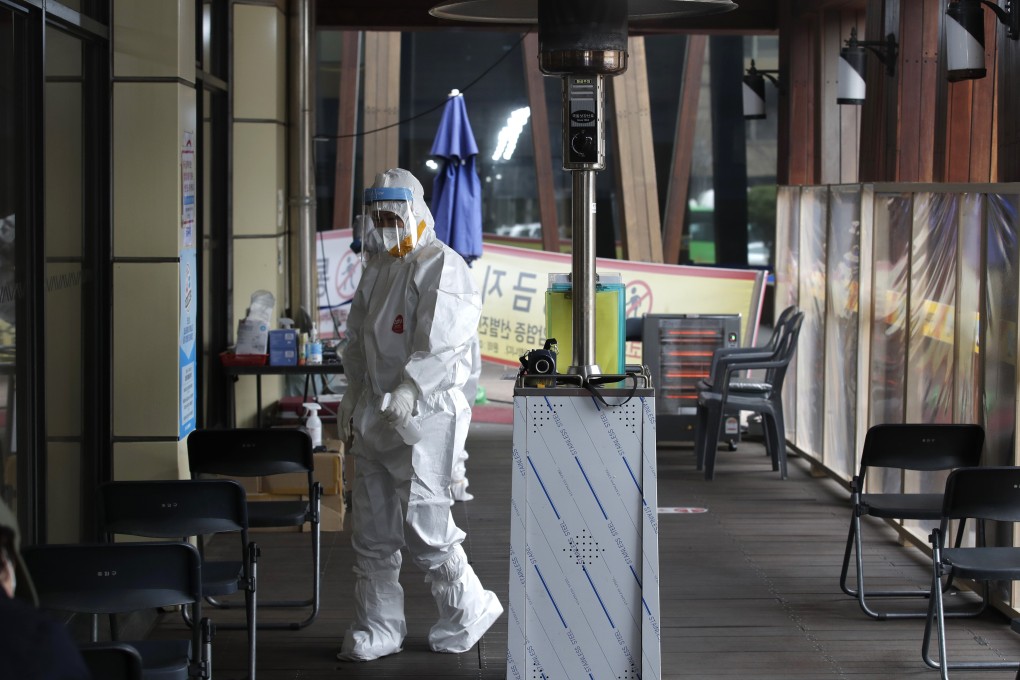 A medical worker sprays disinfectant at a coronavirus testing site in Seoul. Photo: AP