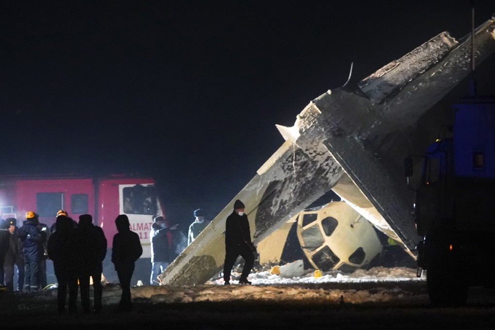 Emergency employees work at the site of a crashed Soviet-built An-26 two-engine turboprop at Almaty airport in Kazakhstan on Saturday. Photo: AP