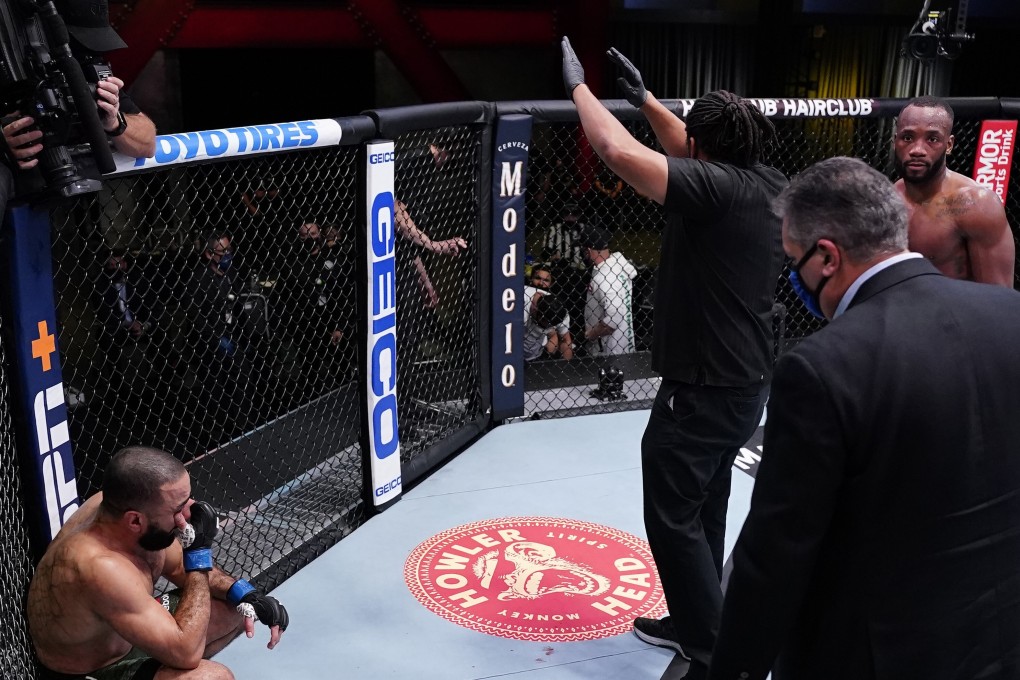Referee Herb Dean calls off the fight between Bulal Muhammad (left) and Leon Edwards after Muhammad was unable to continue because of an accidental eye poke in their welterweight bout during the UFC Fight Night event on March 13, 2021 in Las Vegas, Nevada. Photos: Jeff Bottari/Zuffa LLC via Getty Images