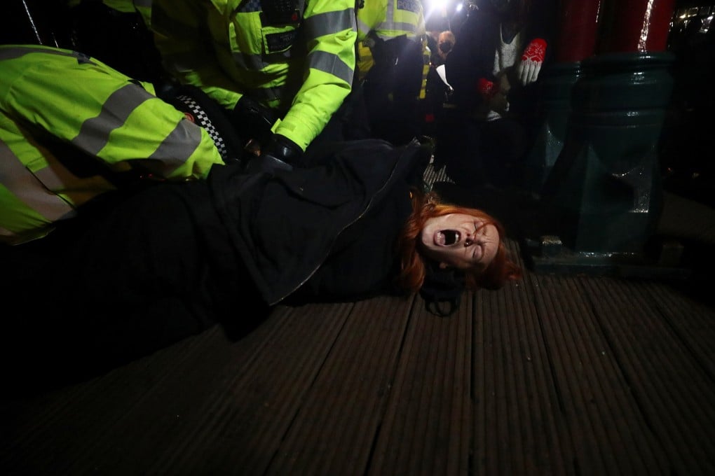 British police detain a woman at a vigil for Sarah Everard in Clapham Common, south London. Photo: Reuters