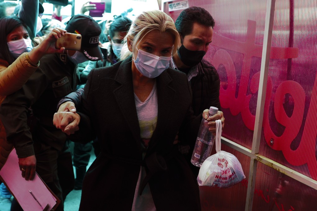 Bolivia's former interim president Jeanine Anez is escorted into a police station in La Paz, Bolivia on Saturday. Photo: AP