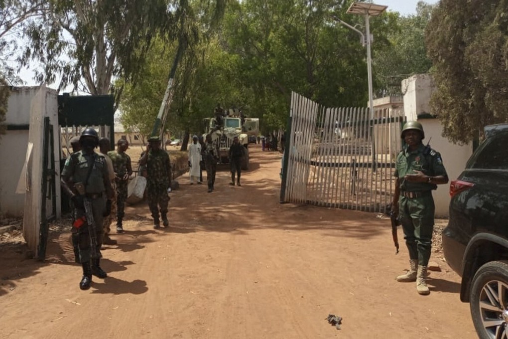 Nigerian soldiers and police officers at the entrance of the Federal College of Forestry Mechanisation in Mando, Kaduna state on Sunday. Photo: AFP