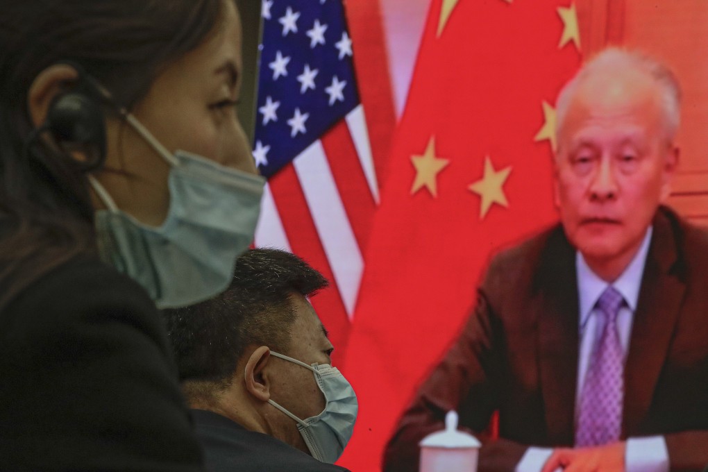 People wearing face masks near a screen showing China’s ambassador to the US Cui Tiankai at the Lanting Forum. Photo: Andy Wong