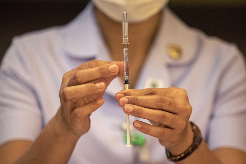 A nurse checks a dose of the AstraZeneca Covid-19 vaccine for air bubbles. Photo: Bloomberg