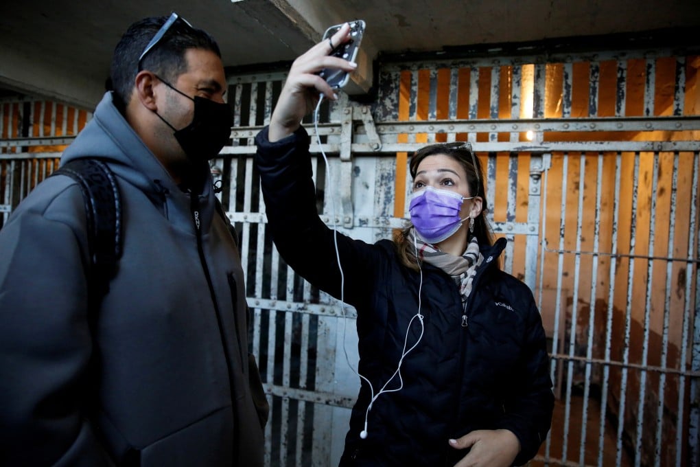 A visitor takes a selfie in front of the jail cells as Alcatraz Island and the famous former prison reopens to the public for indoor tours. Photo: Reuters