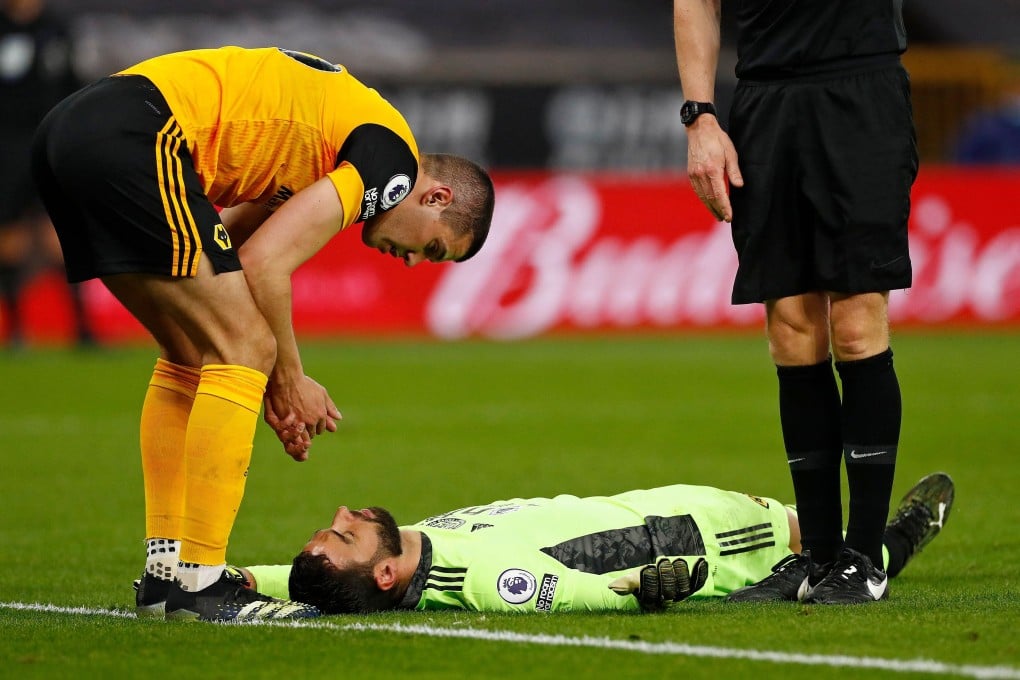 Wolverhampton Wanderers defender Conor Coady (left) talks to a stricken Rui Patricio after a clash between the two. Photo: AFP