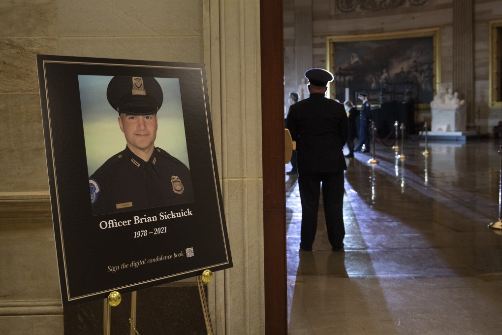 A placard is displayed with an image of the late US Capitol Police officer Brian Sicknick who was killed in the January 6 riot in Washington. Photo: AP