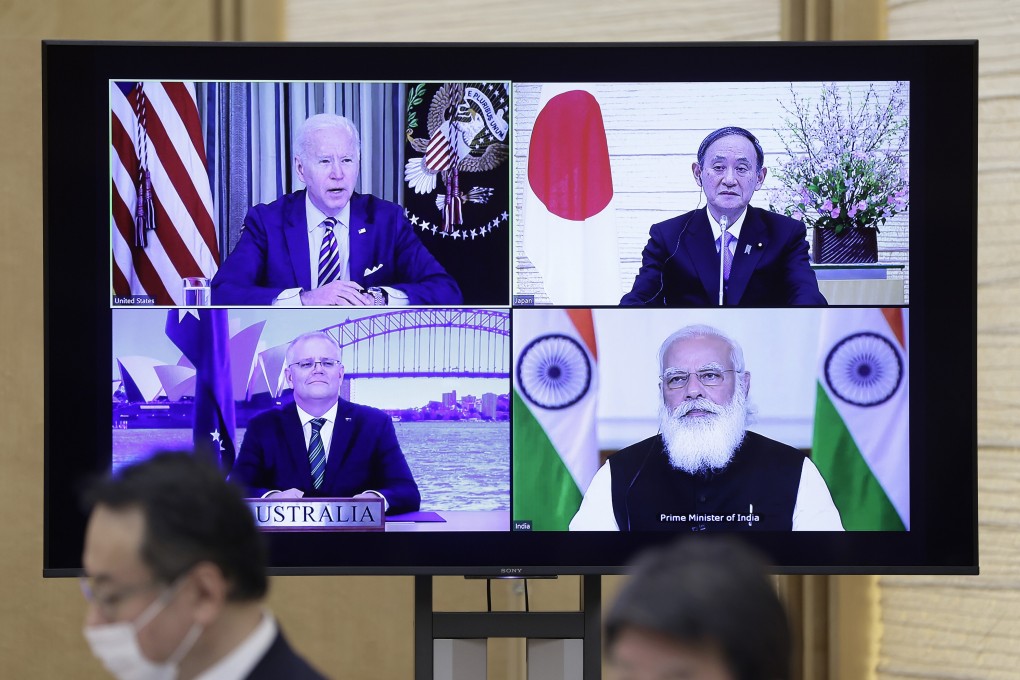 A monitor in Tokyo displays the virtual ‘Quad’ meeting of (clockwise from top left) US President Joe Biden, Japan’s Prime Minister Yoshihide Suga, India’s Prime Minister Narendra Modi and Australia’s Prime Minister Scott Morrison. Photo: Bloomberg