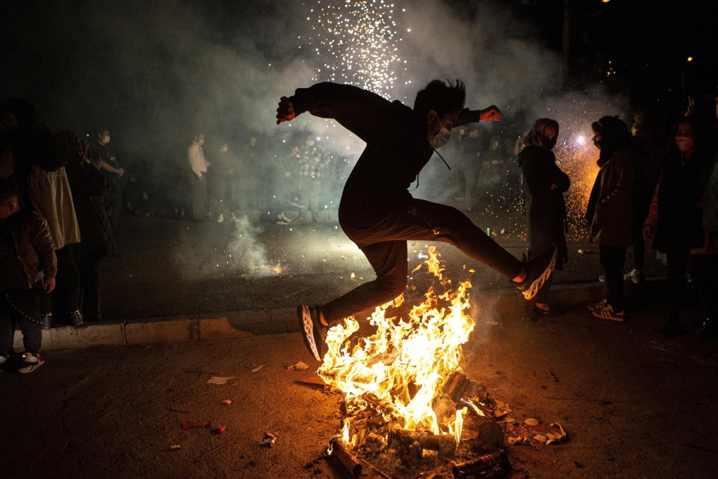 A man jumps over a bonfire as part of Chaharshanbe Suri celebrations in Tehran. Photo: Xinhua
