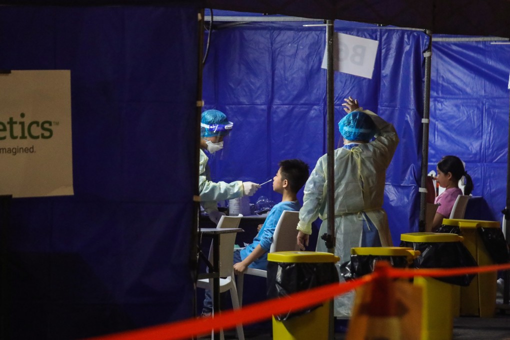 Residents in Sai Ying Pun are screened for Covid-19 at a mobile testing centre on Wednesday night. Photo: Xiaomei Chen