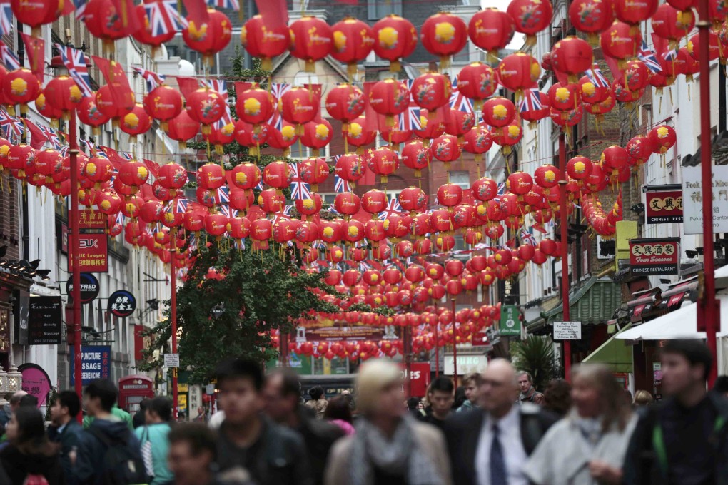Chinese and British flags and paper lanterns are strung across London’s Chinatown. Photo: Reuters