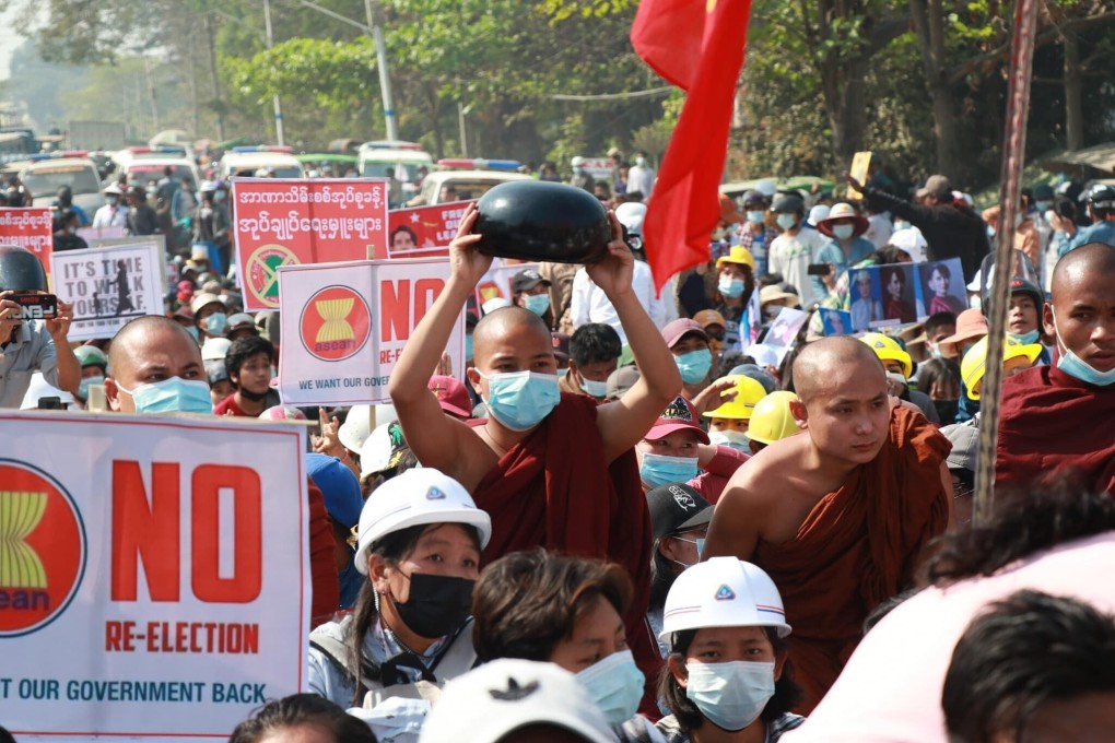 A street protest in Kalaymyo, Sagaing division, Myanmar, on March 1. Monks in Myanmar have to accept whatever food their worshippers serve, but this monk holds his begging bowl upside down, to show he would not accept donations from the military junta. Photo: Sanguk Cung