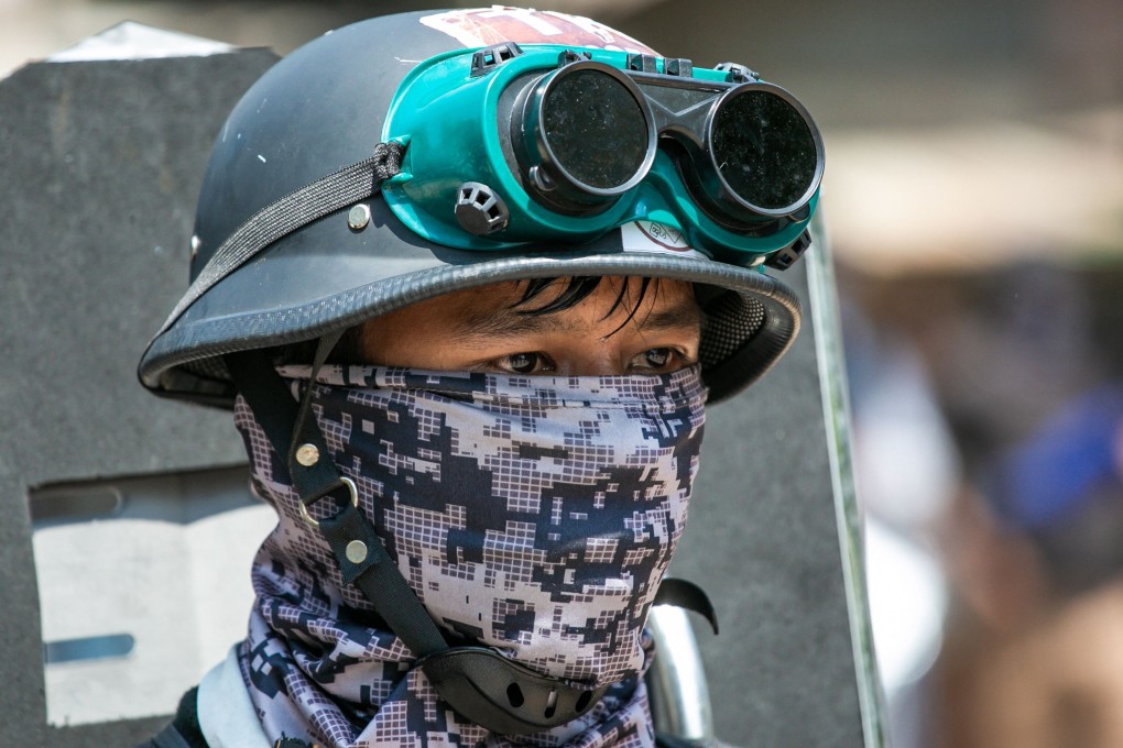A masked protester at a demonstration against the military coup in Yangon. Photo: AFP