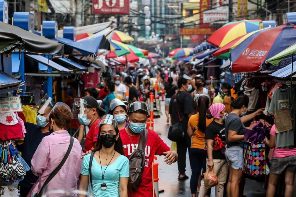People wearing face masks are seen on a busy street in Manila. The Philippines recorded a surge in Covid-19 cases over the weekend. Photo: Xinhua